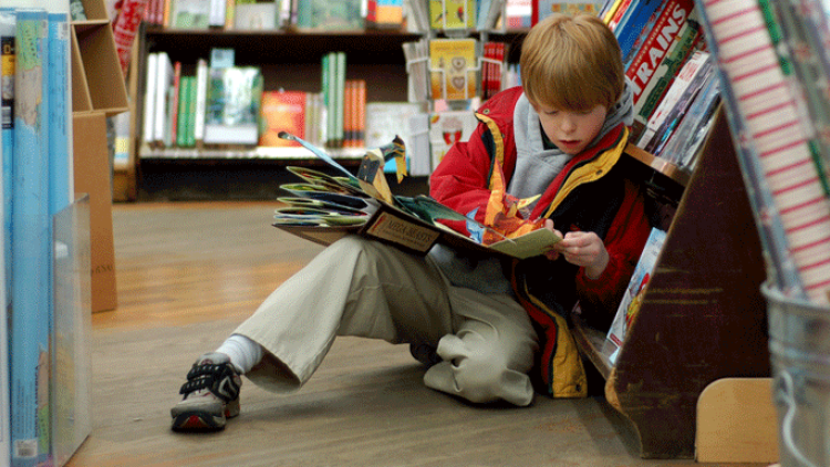 boy reading in library