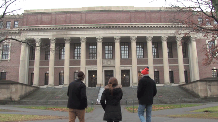 three students in front of widener library
