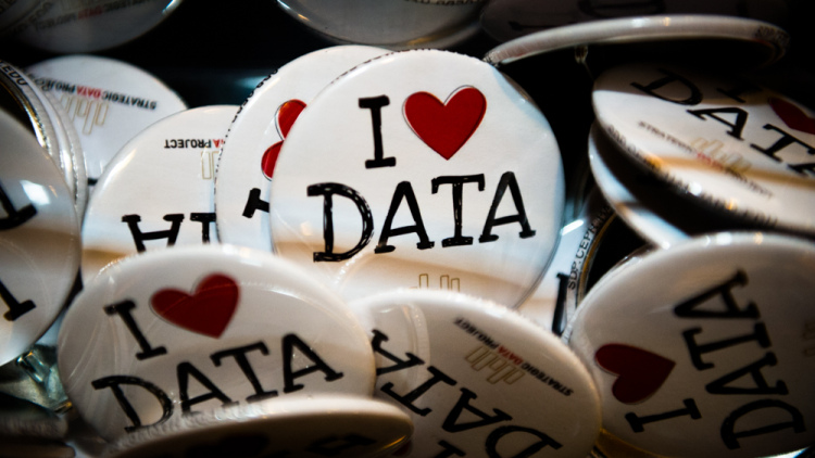 lapel pins reading "I heart data"
