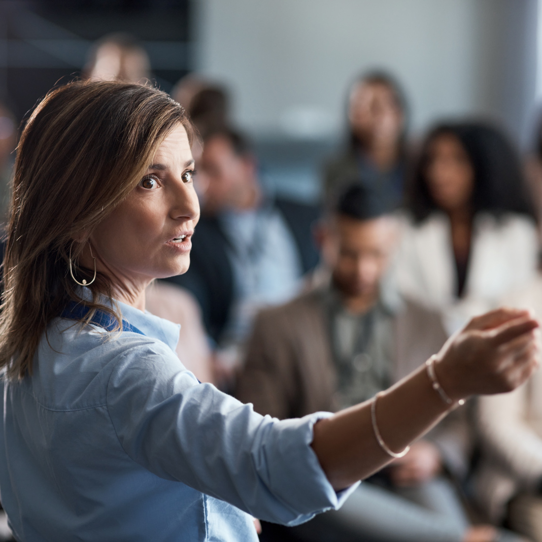 Woman delivers a presentation at a conference.