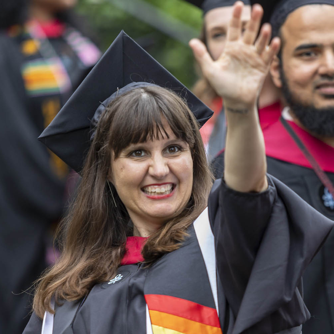 Graduate waving