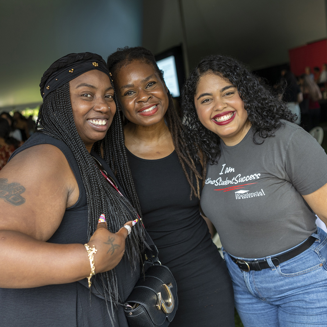 Three students smiling during a break at HGSE Welcome Day