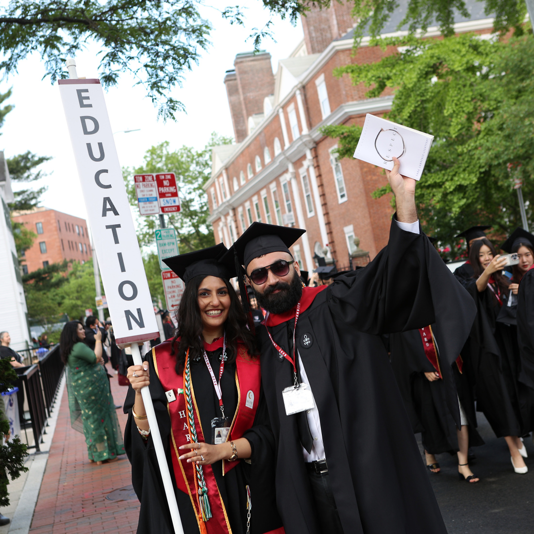 Grads holding Education sign