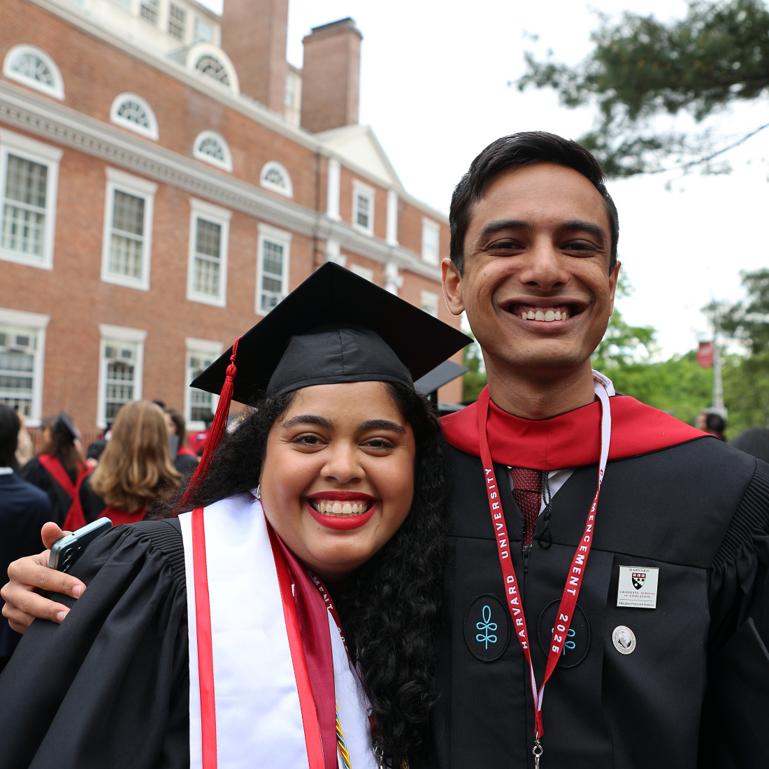 Pair of grads smiling