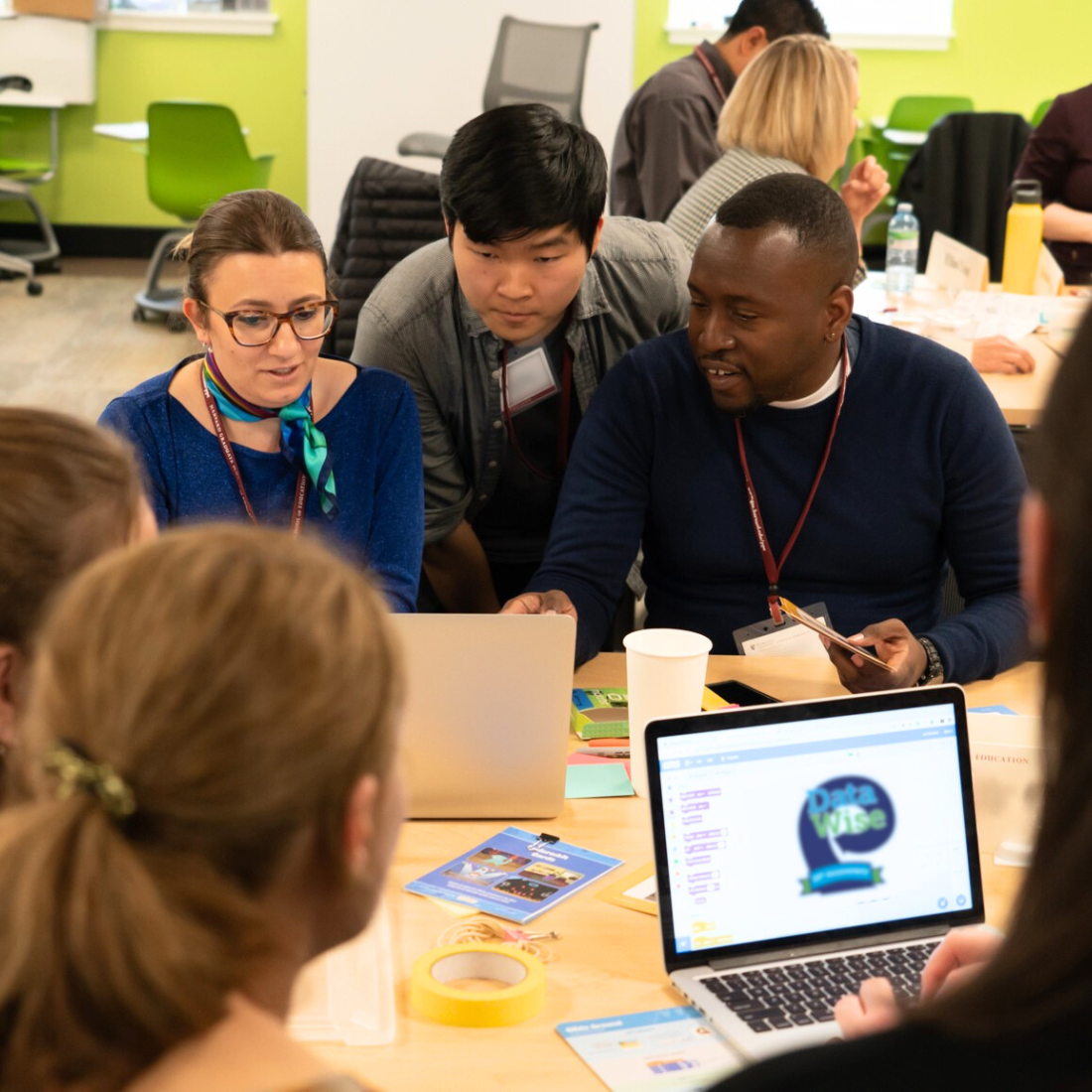 A team collaborates at a table in Longfellow Hall