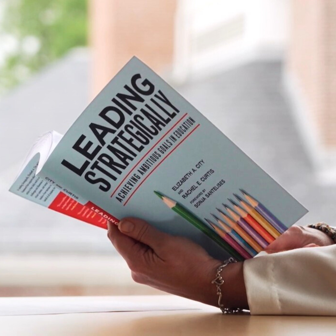 Person reading Leading Strategically book
