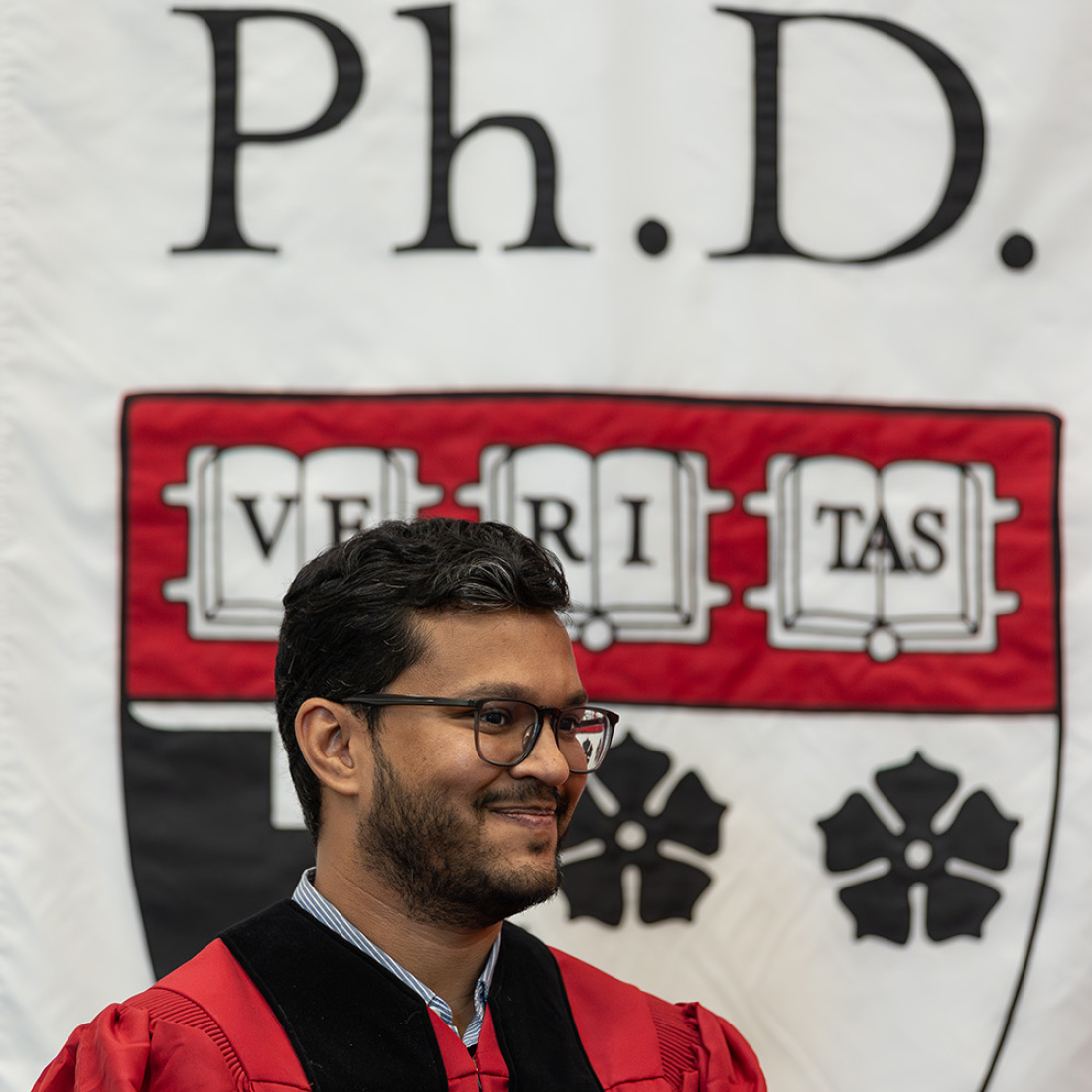 Ph.D. student in front of banner