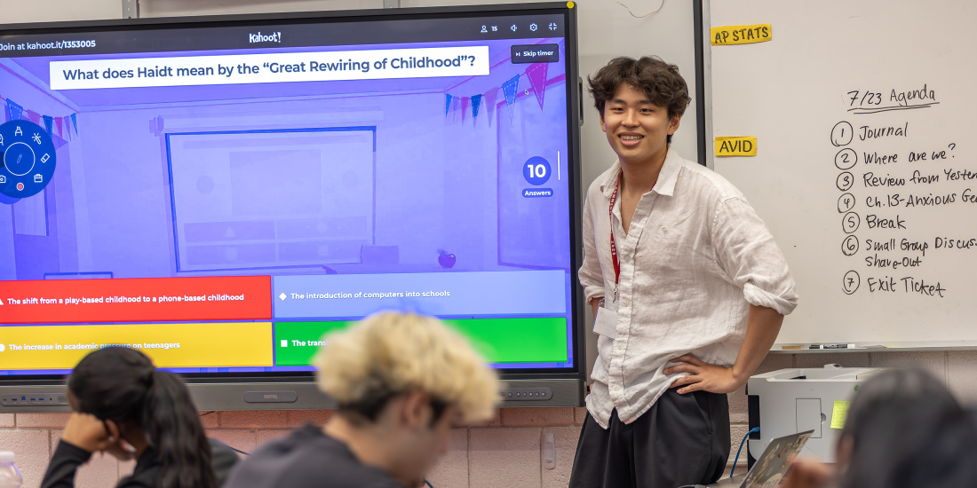 Young male teacher at smartboard