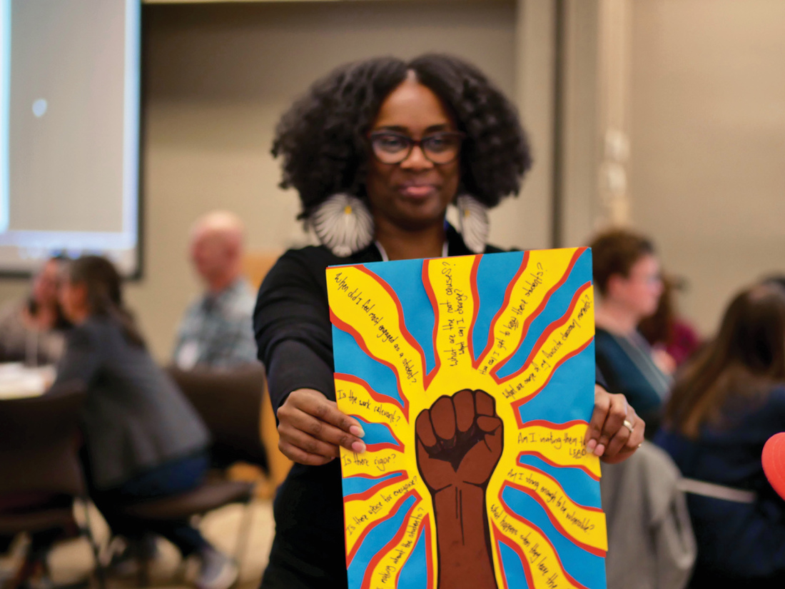 A black woman presents art with a brown-skinned fist surrounded by key questions about education and motivation