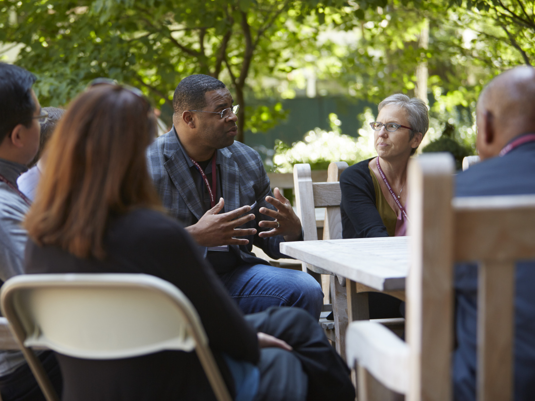A group of participation collaborate in a group outside the library.