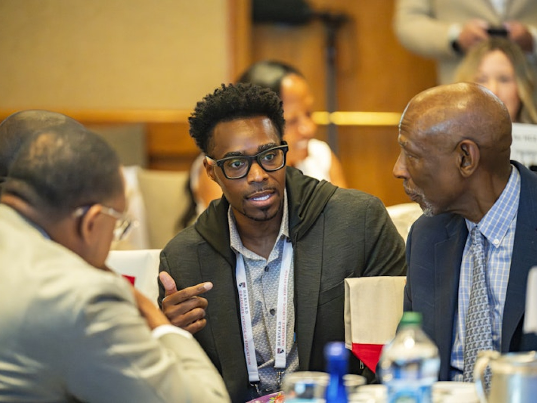 Geoffrey Canada (right) has a conversation with peers